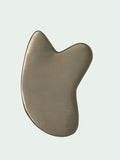Kansa Gua Sha on sage backdrop