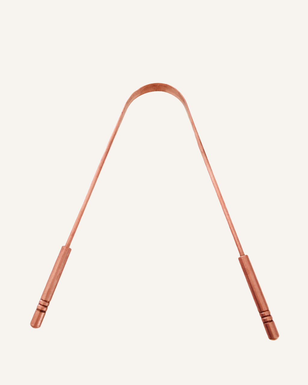 Copper Tongue Scraper on cream backdrop