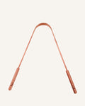 Copper Tongue Scraper on cream backdrop
